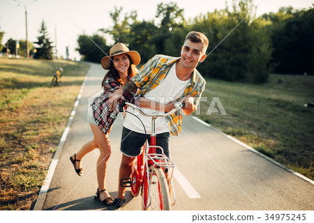 Love couple fun in summer park, vintage bicycle Love couple fun in summer park, vintage bicycle 34975245