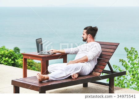 Businessman wearing white using laptop on the 34975541