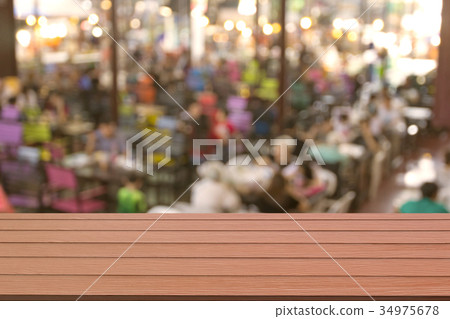 Wooden table with blur restaurant background Wooden table with blur restaurant background 34975678