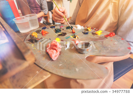 Scaled up view on artist mixing bright paints on Scaled up view on artist mixing bright paints on 34977788