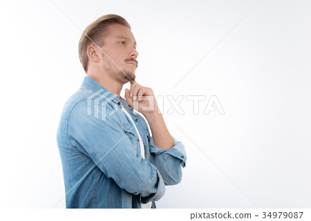 Young fair-haired man thinking about crucial 34979087