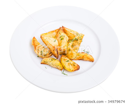 Baked potato wedges with minced dill. Baked potato wedges with minced dill. 34979674