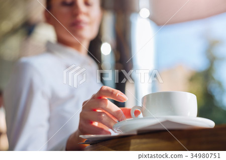Female hands taking a cup of coffee 34980751