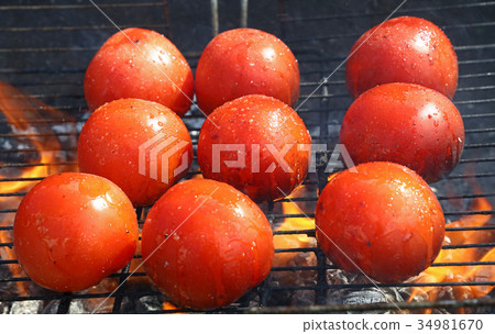 Red tomatoes cooked on bbq grill close up Red tomatoes cooked on bbq grill close up 34981670