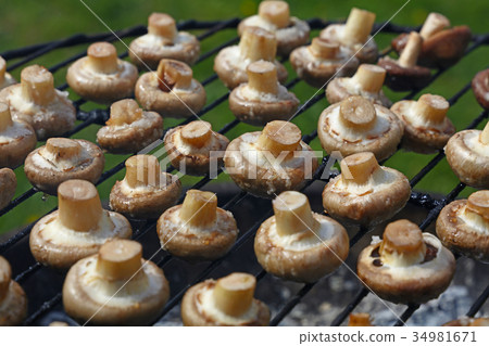 White champignons mushrooms on grill White champignons mushrooms on grill 34981671
