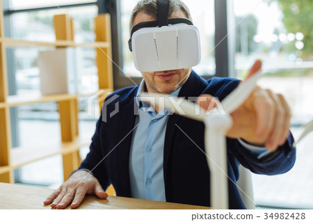 Nice confident man looking at the windmill model 34982428