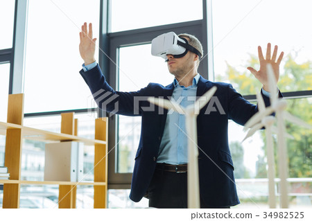 Smart pleasant man using modern technologies 34982525