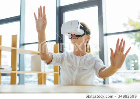 Joyful positive woman testing 3d technology 34982599