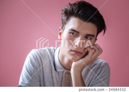 Thoughtful boy touching his chin 34984332