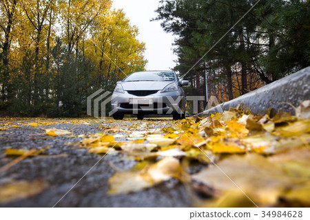 Japanese hatchback on autumn road Japanese hatchback on autumn road 34984628