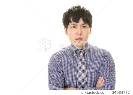 與一個疲乏的表示的一個商人 與一個疲乏的表示的一個商人 34984772