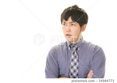 與一個疲乏的表示的一個商人 與一個疲乏的表示的一個商人 34984773