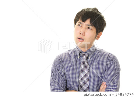 與一個疲乏的表示的一個商人 與一個疲乏的表示的一個商人 34984774