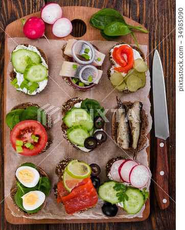 Various bruschettas on wooden background. 34985090