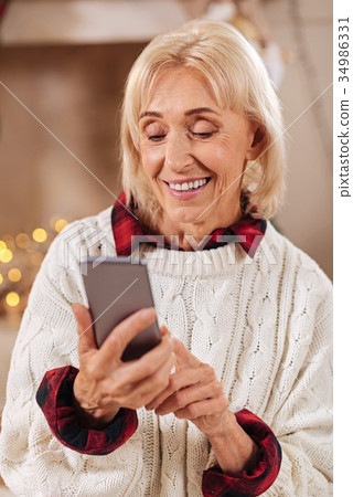 Portrait of delighted woman that looking at her 34986331