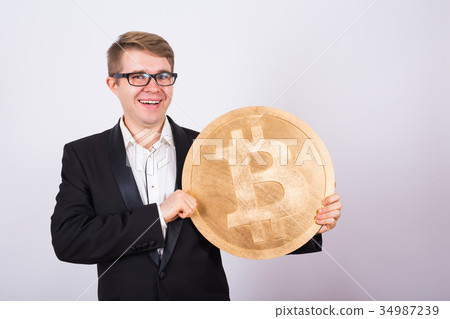 Happy cheerful young businessman holding big 34987239