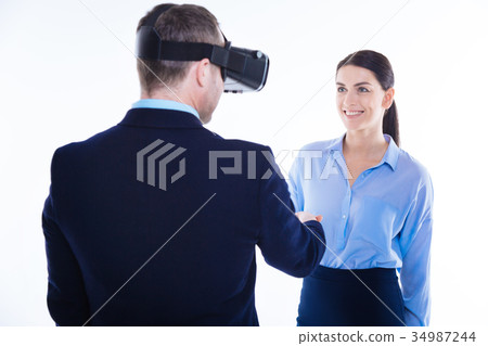 Happy positive woman greeting her colleague Happy positive woman greeting her colleague 34987244
