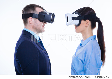 Nice pleasant man and woman standing opposite each Nice pleasant man and woman standing opposite each 34987247