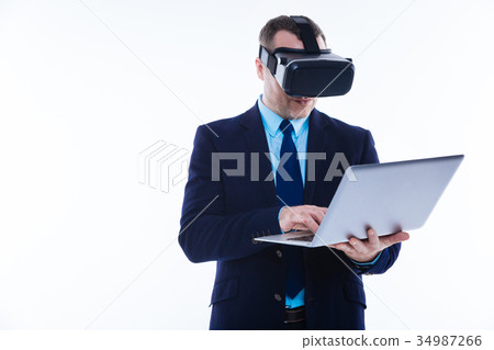 Nice handsome man holding a laptop 34987266