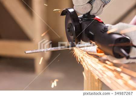 cutting metal with angle grinder, sparks from the cutting metal with angle grinder, sparks from the 34987267