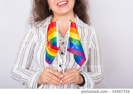Close up of lesbian woman holding flags of the Close up of lesbian woman holding flags of the 34987356