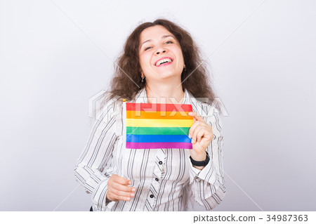 Young lesbian woman holding flags of the LGBT Young lesbian woman holding flags of the LGBT 34987363