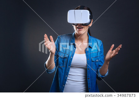 Joyful emotional woman being in virtual reality Joyful emotional woman being in virtual reality 34987873