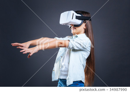 Delighted nice girl putting hands in front of her 34987990