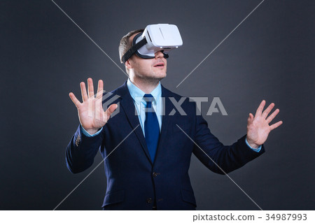Nice handsome man experiencing virtual world Nice handsome man experiencing virtual world 34987993