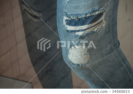 torned blue jeans in women store showroom 34988653