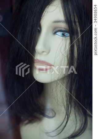 closeup of wig on mannequin in showroom 34988654