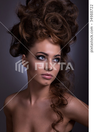 Portrait of a beautiful girl with a creative high hairstyle and Portrait of a beautiful girl with a creative high hairstyle and 34988722