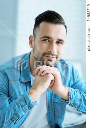 Relaxed millennial guy looking into camera and 34988749
