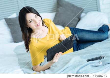 Beautiful young brunette with tablet computer 34988757