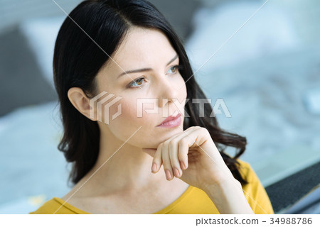 Pensive brunette girl thinking over something Pensive brunette girl thinking over something 34988786