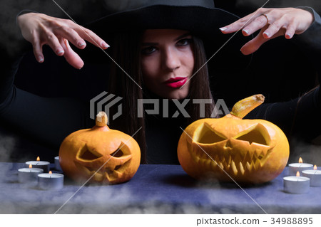Halloween Witch with a magic Pumpkin. Halloween Witch with a magic Pumpkin. 34988895