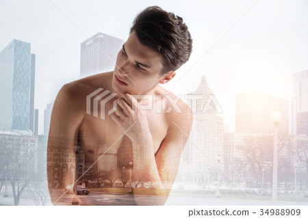 Naked model touching his chin and looking away Naked model touching his chin and looking away 34988909