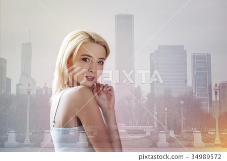 Lovely model touching her face with a finger Lovely model touching her face with a finger 34989572