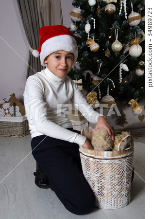 Smiling boy is taking out teddy bear from basket Smiling boy is taking out teddy bear from basket 34989723