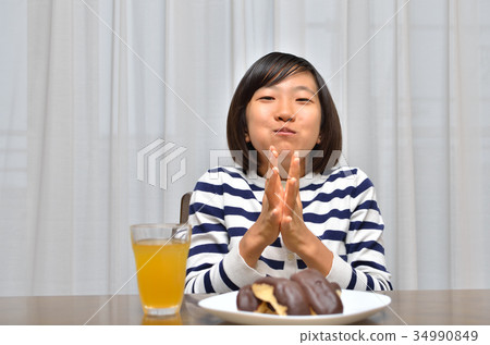 A girl who eats Eclair deliciously A girl who eats Eclair deliciously 34990849