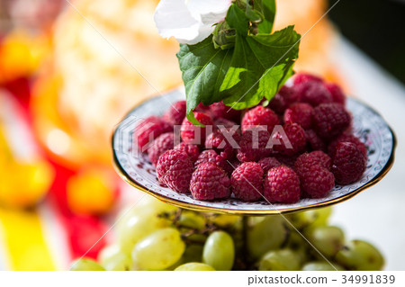 ripe raspberries on a plate ripe raspberries on a plate 34991839