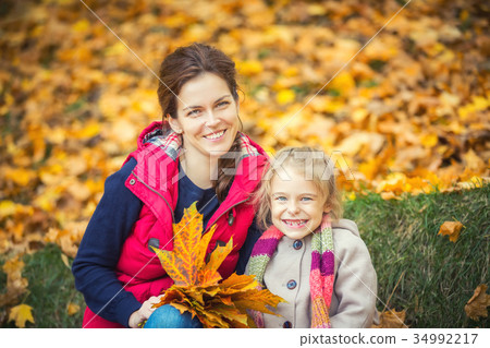 Mother and daughter in the autumn park Mother and daughter in the autumn park 34992217