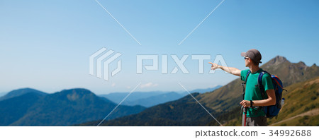 Photo of tourist guy pointing away from scenic 34992688