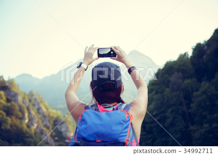 Image from the back of tourist girl with backpack 34992711