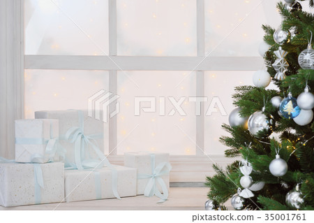 Christmas presents in white boxes on a window Christmas presents in white boxes on a window 35001761