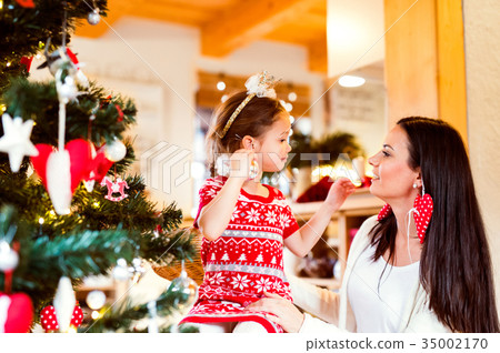 Young mother with daughter at Christmas tree at Young mother with daughter at Christmas tree at 35002170