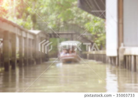 Canal in countryside wiht boat blur background Canal in countryside wiht boat blur background 35003733
