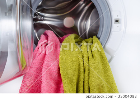 color towels in a open wash machine closeup 35004088