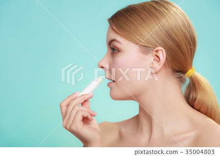woman applying balsam for lips woman applying balsam for lips 35004803