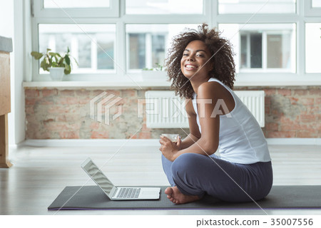 Cheerful female typing on digital device Cheerful female typing on digital device 35007556